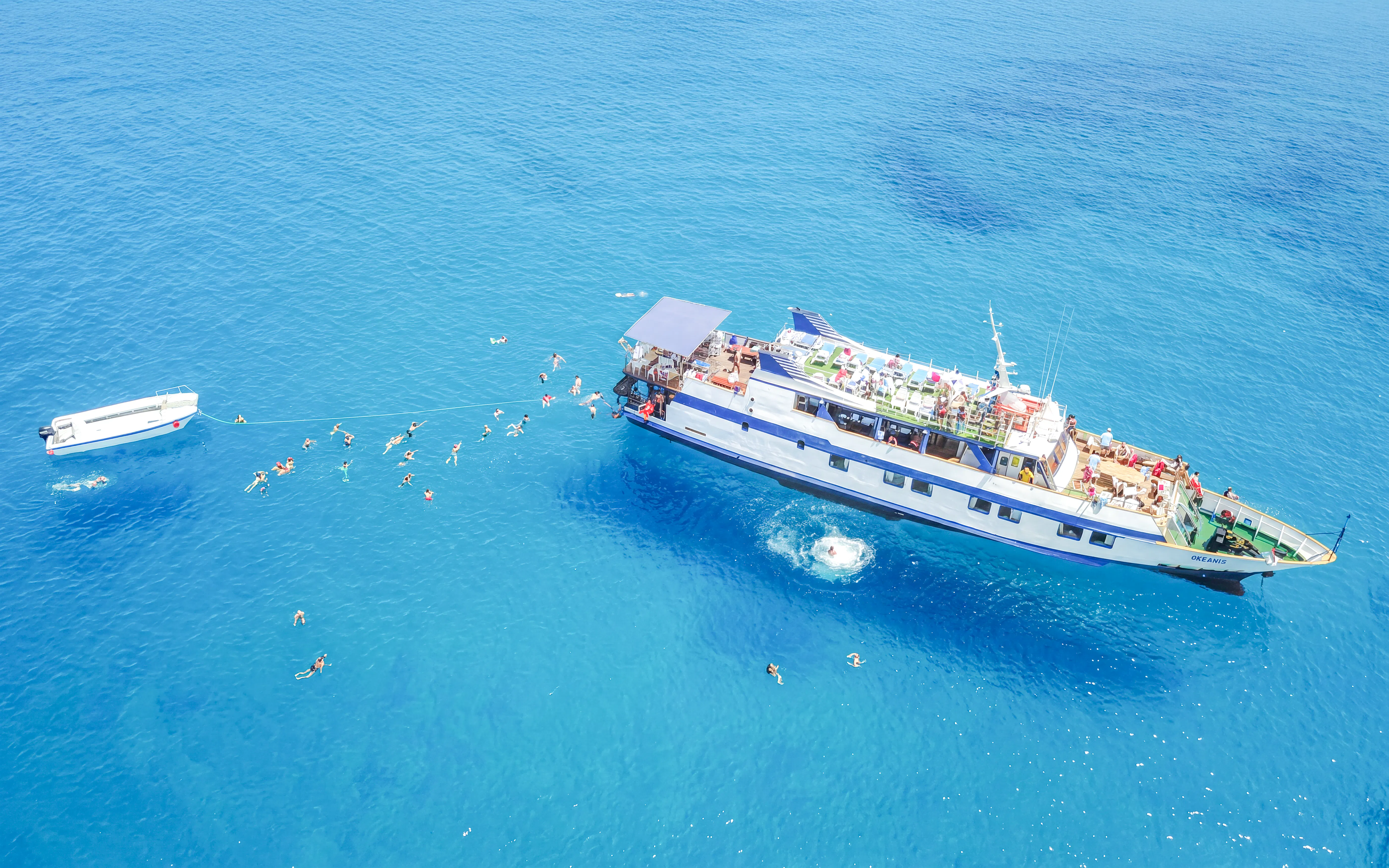 Cruise ship with swimmers in Blue Lagoon, Larnaca.