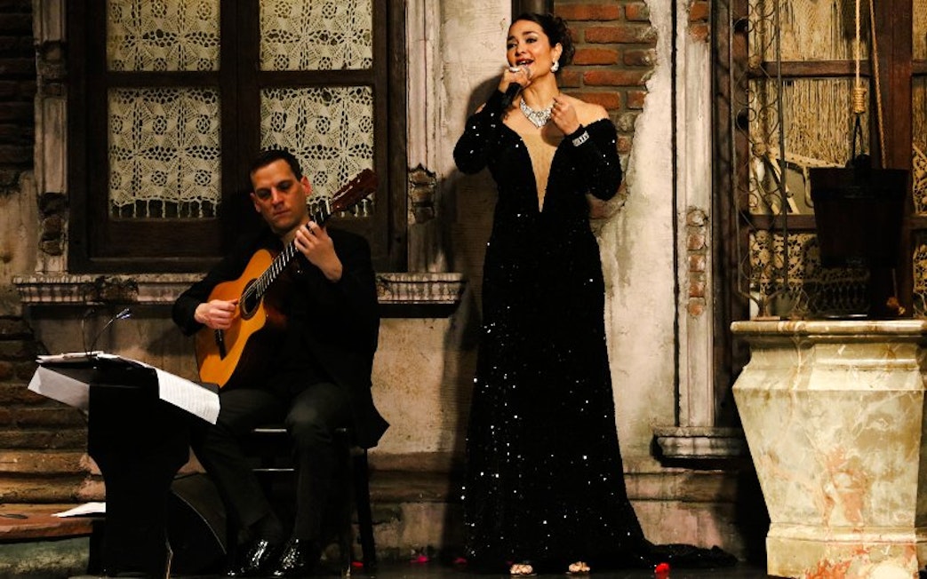 Tango singer and guitarist performing at Aljibe Tango Show in Buenos Aires.