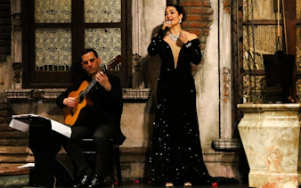 Tango singer and guitarist performing at Aljibe Tango Show in Buenos Aires.