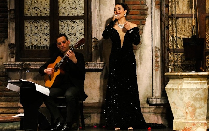Tango singer and guitarist performing at Aljibe Tango Show in Buenos Aires.