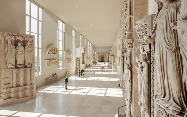 Sculptures displayed in a sunlit gallery at Notre-Dame de Paris Exhibition.