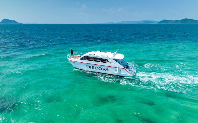 Speedboat on turquoise waters during Phuket Sunset Tour, Phi Phi Island, Maya Bay.