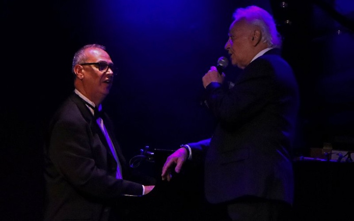 Singer performing with pianist at Michelangelo Tango Show in Buenos Aires.