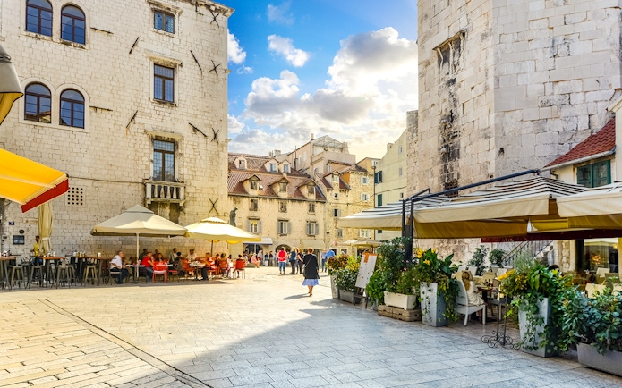 Diocletian's Palace courtyard with cafes and tourists in Split's Old Town.