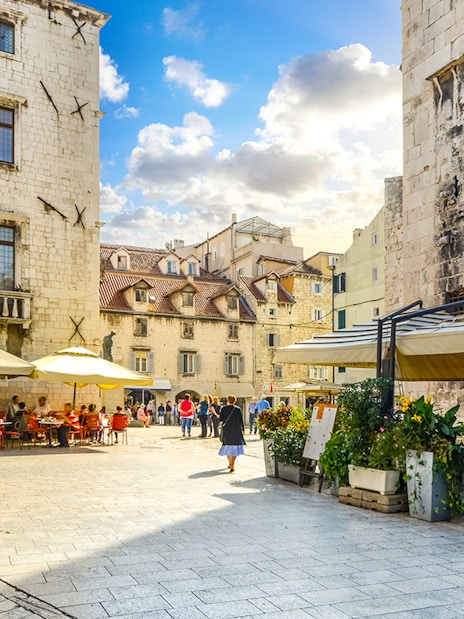 Diocletian's Palace courtyard with cafes and tourists in Split's Old Town.