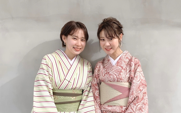 Individuals wearing traditional Japanese kimono clothing.