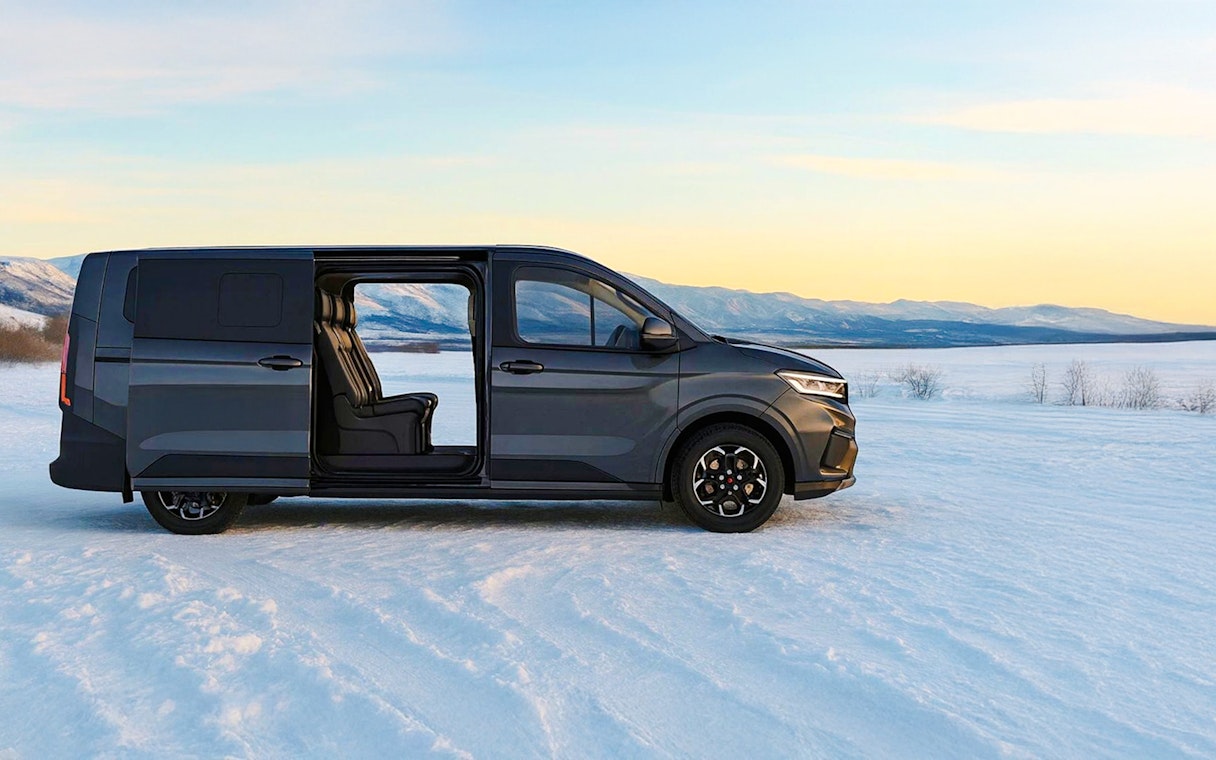 Minivan on snowy landscape, Levi transfer service.
