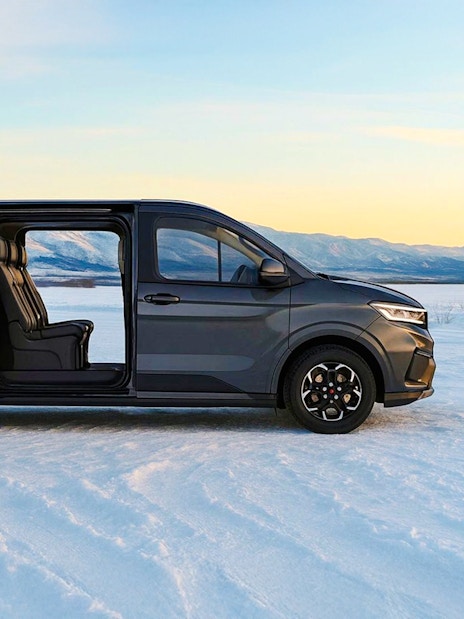 Minivan on snowy landscape, Levi transfer service.