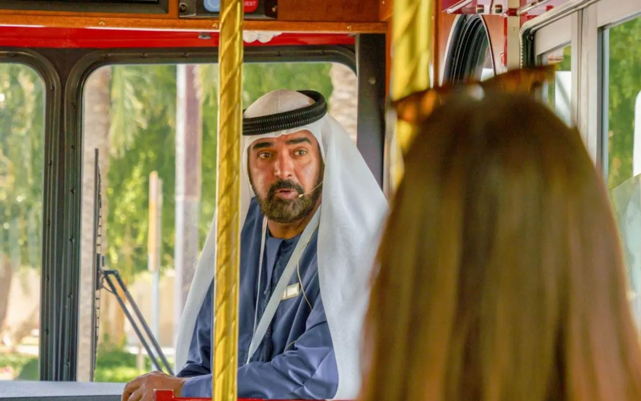 Emirati storyteller narrating on Dubai traditional trolley tour.