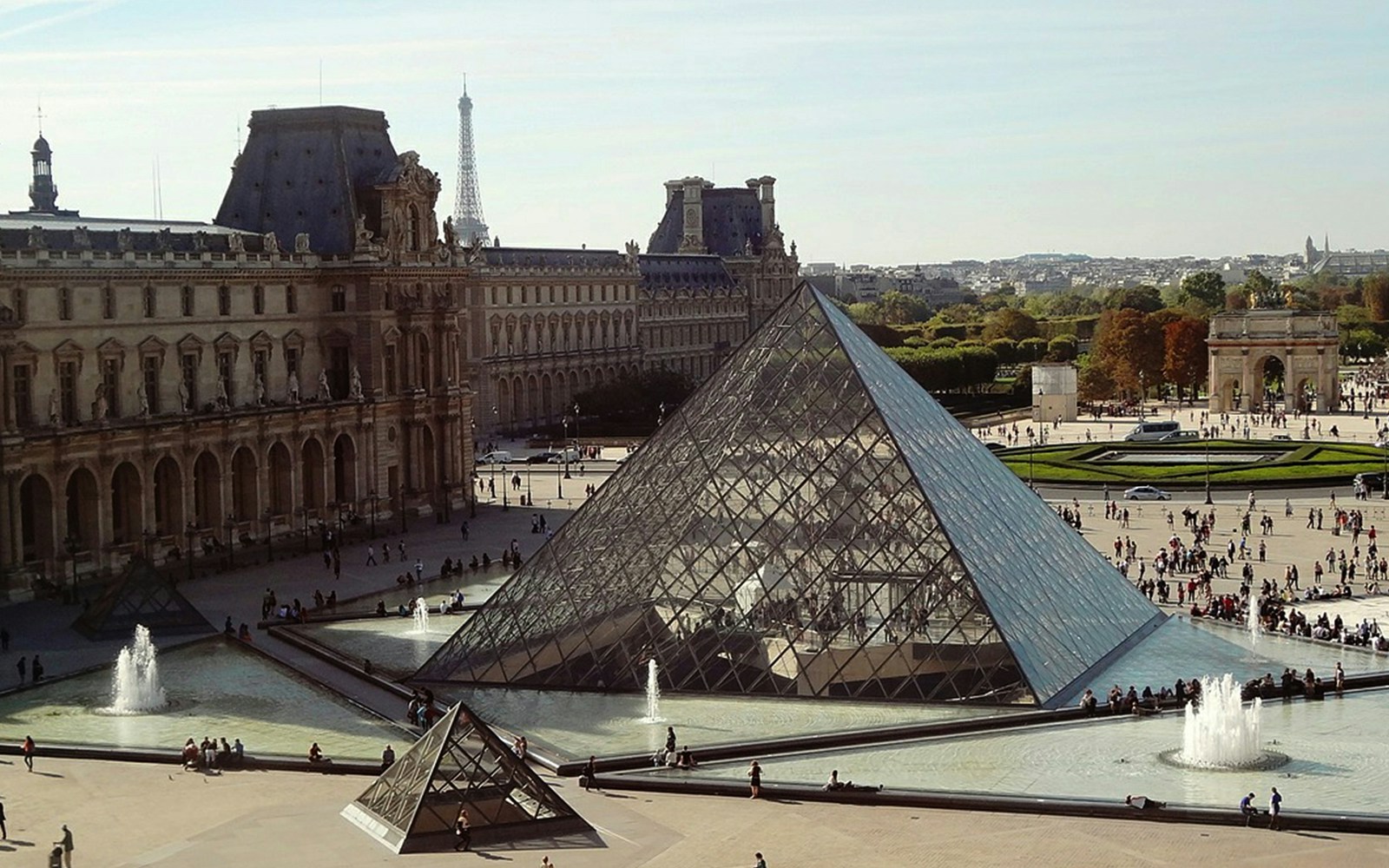 Aerial view of the Louvre Pyramid and surrounding courtyard in Paris.