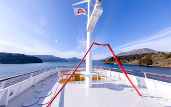 Upper deck view of Hakone Sightseeing Cruise with Lake Ashi and mountains in the background.
