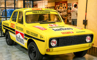 Yellow car with Pablo Escobar branding at the Pablo Escobar Museum in Medellin.