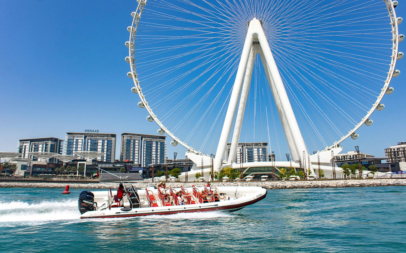 Speedboat cruising Dubai Marina with views of Atlantis, Palm Jumeirah, and Burj Al Arab.