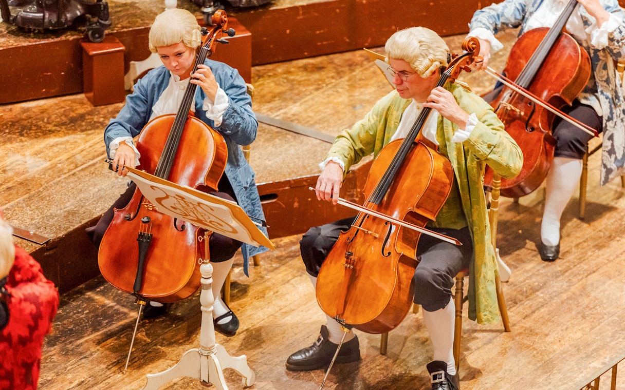 Cellists performing at the Musikverein Vienna during a Mozart concert.