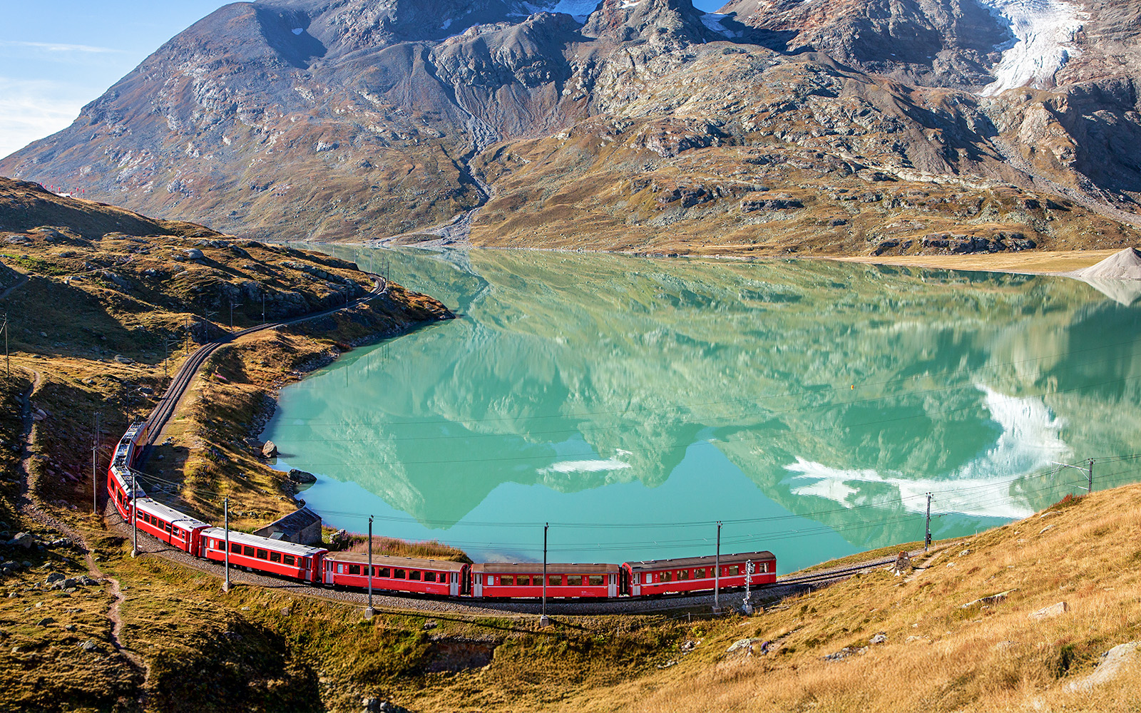 Lago Bianco aerial view with the Bernina Express in sight during summer.
