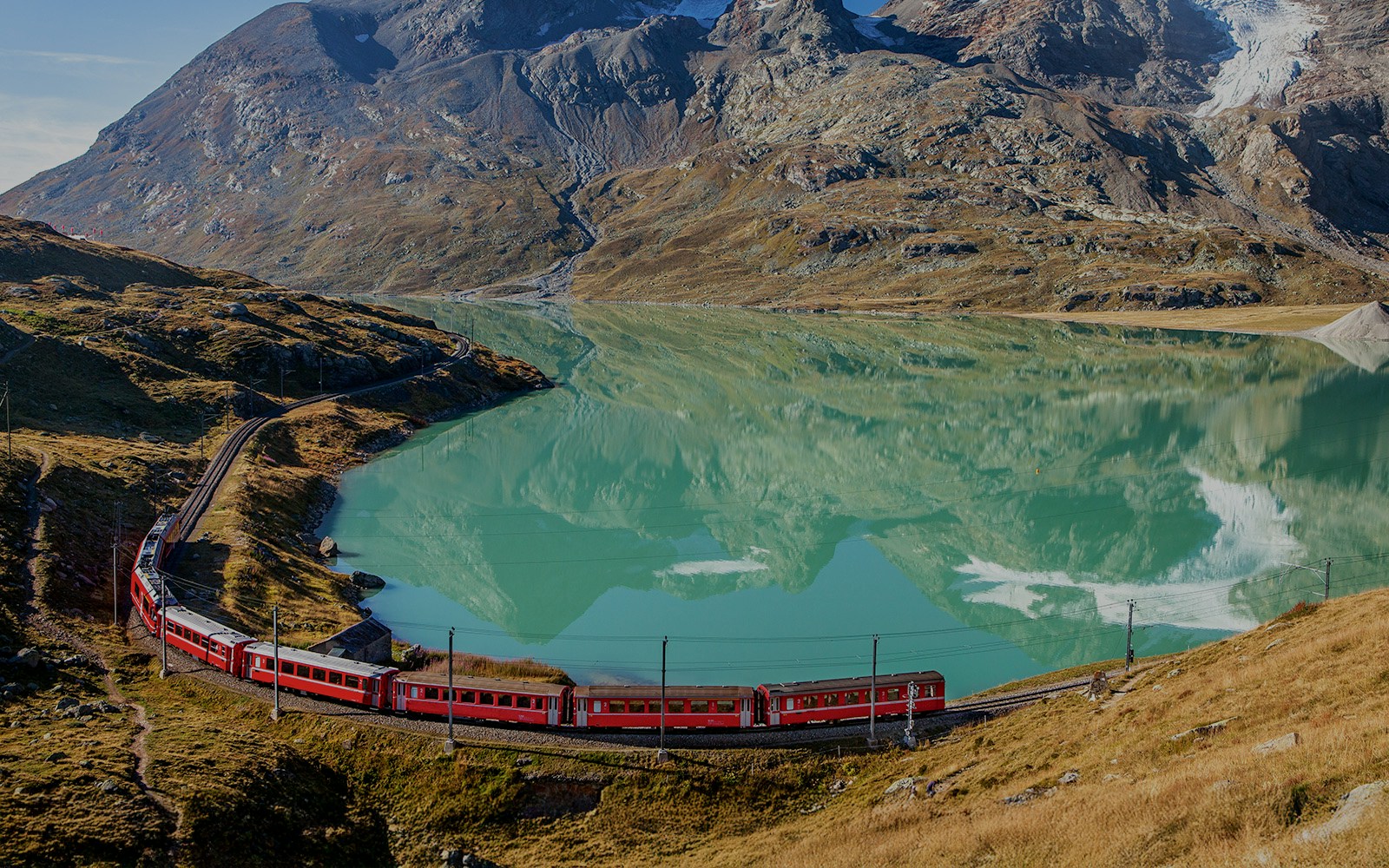 Lago Bianco aerial view with the Bernina Express in sight during summer.