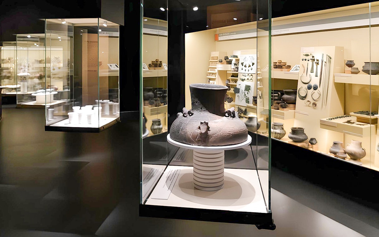 Ancient pottery display inside Bratislava Castle museum exhibit.