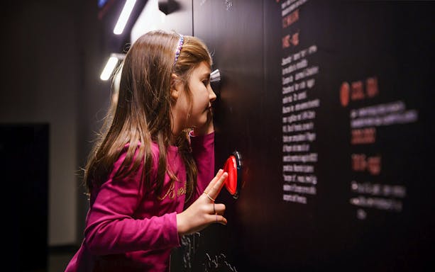 Girl engaging with interactive exhibit at History of Medicine Museum.