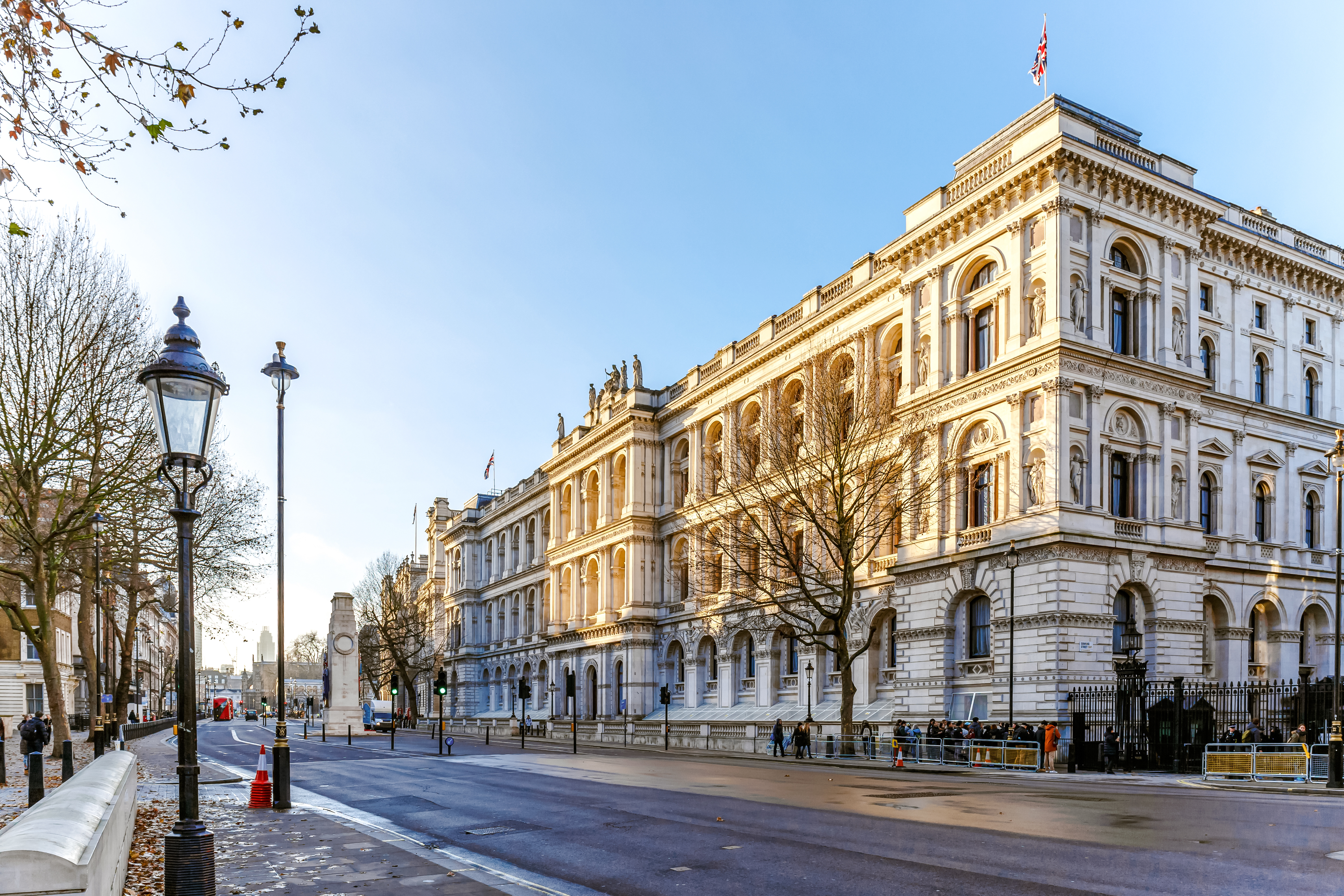Downing Street in winter morning with historic building and bare trees.
