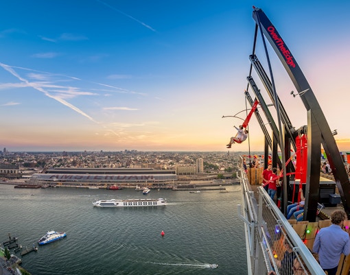 Wide-angle view from A’DAM Lookout of Amsterdam skyline and canals.