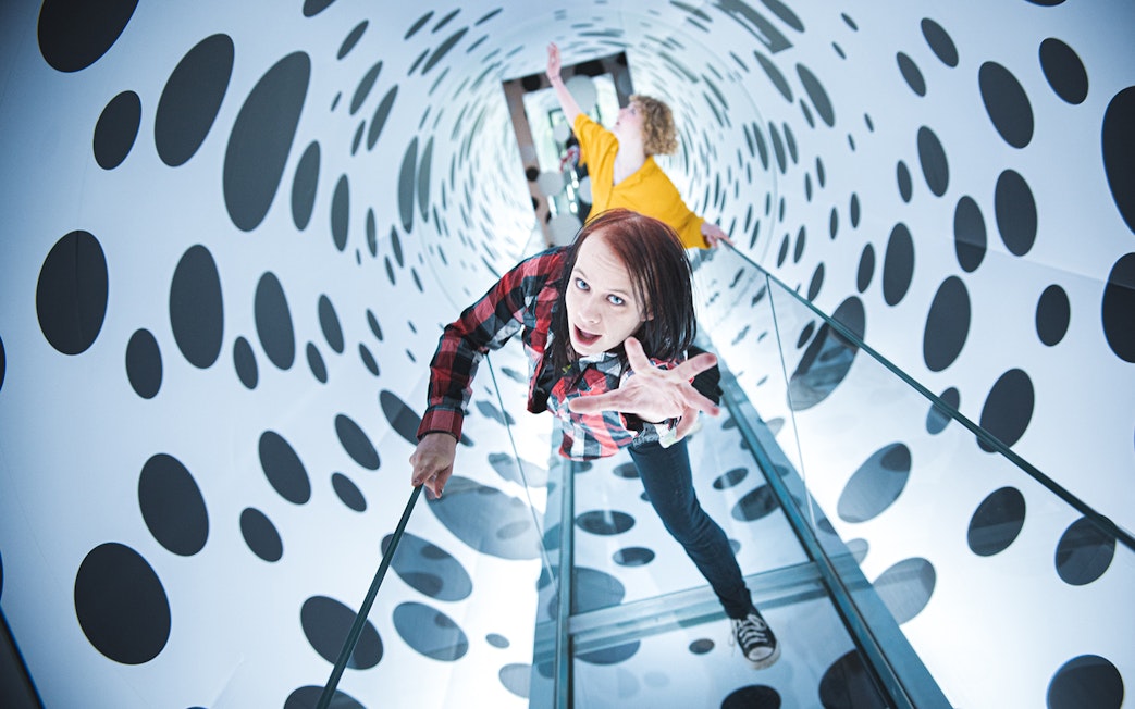 Visitors exploring an optical illusion tunnel at Paradox Museum, Stockholm.
