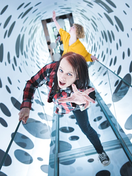Visitors exploring an optical illusion tunnel at Paradox Museum, Stockholm.