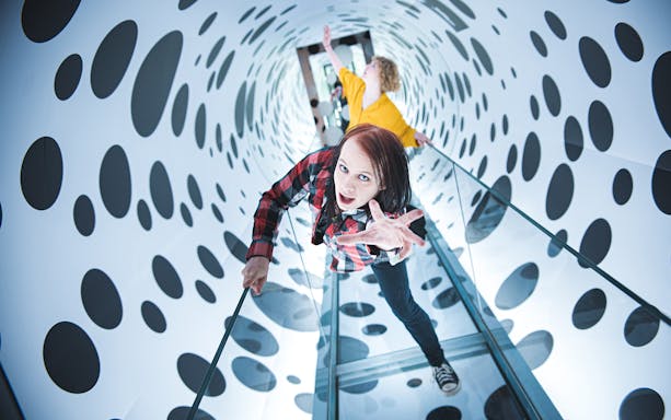 Visitors exploring an optical illusion tunnel at Paradox Museum, Stockholm.