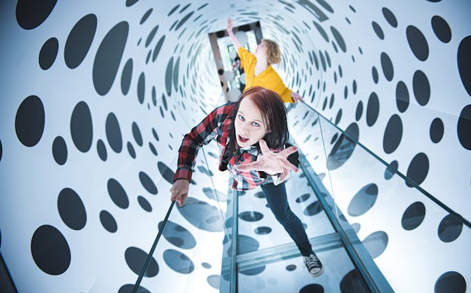 Visitors exploring an optical illusion tunnel at Paradox Museum, Stockholm.