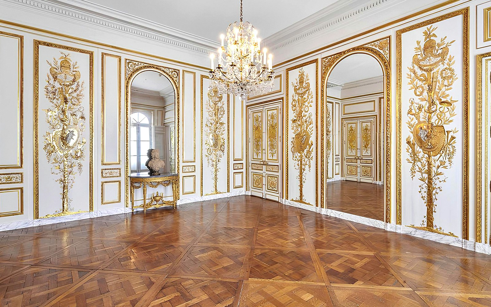 Elegant room with ornate gold detailing and chandelier at Carnavalet Museum, Paris.