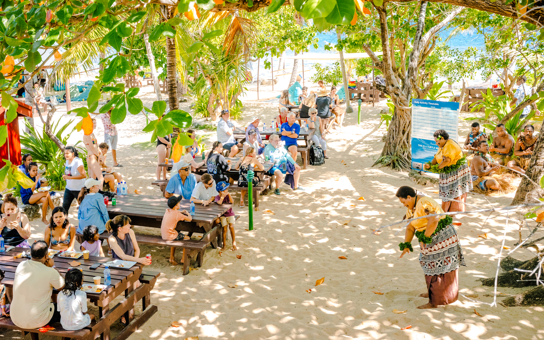 Meke dancers performing for guests during lunchtime on South Sea Island, Fiji.