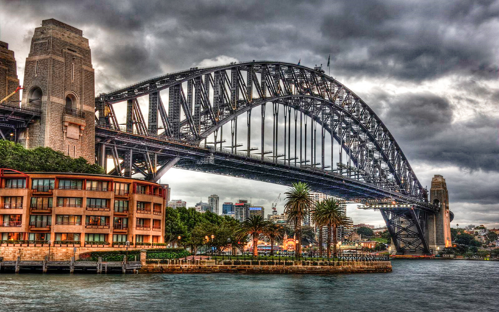 Sydney Harbour Bridge under cloudy sky, part of the True Crime Stories Guided Tour.