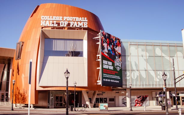 Chick-fil-A College Football Hall of Fame entrance, Atlanta, featuring football-themed displays.