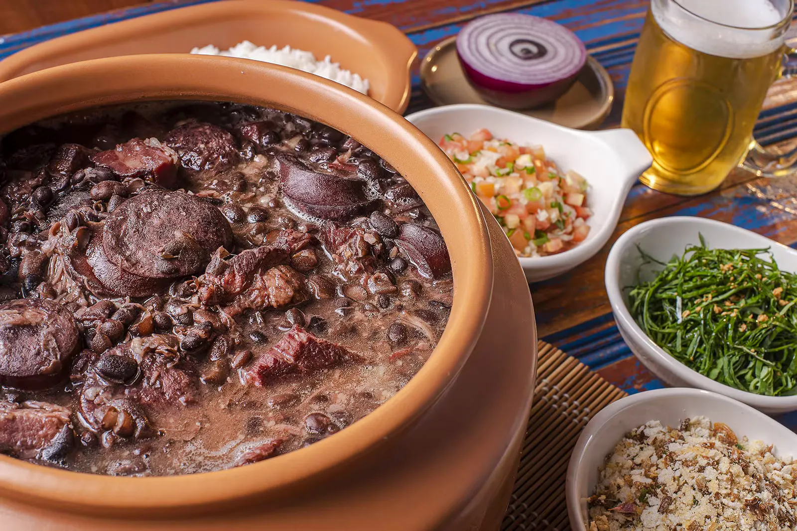 Feijoada dish with sides of rice, greens, and salsa on Rio de Janeiro food tour.