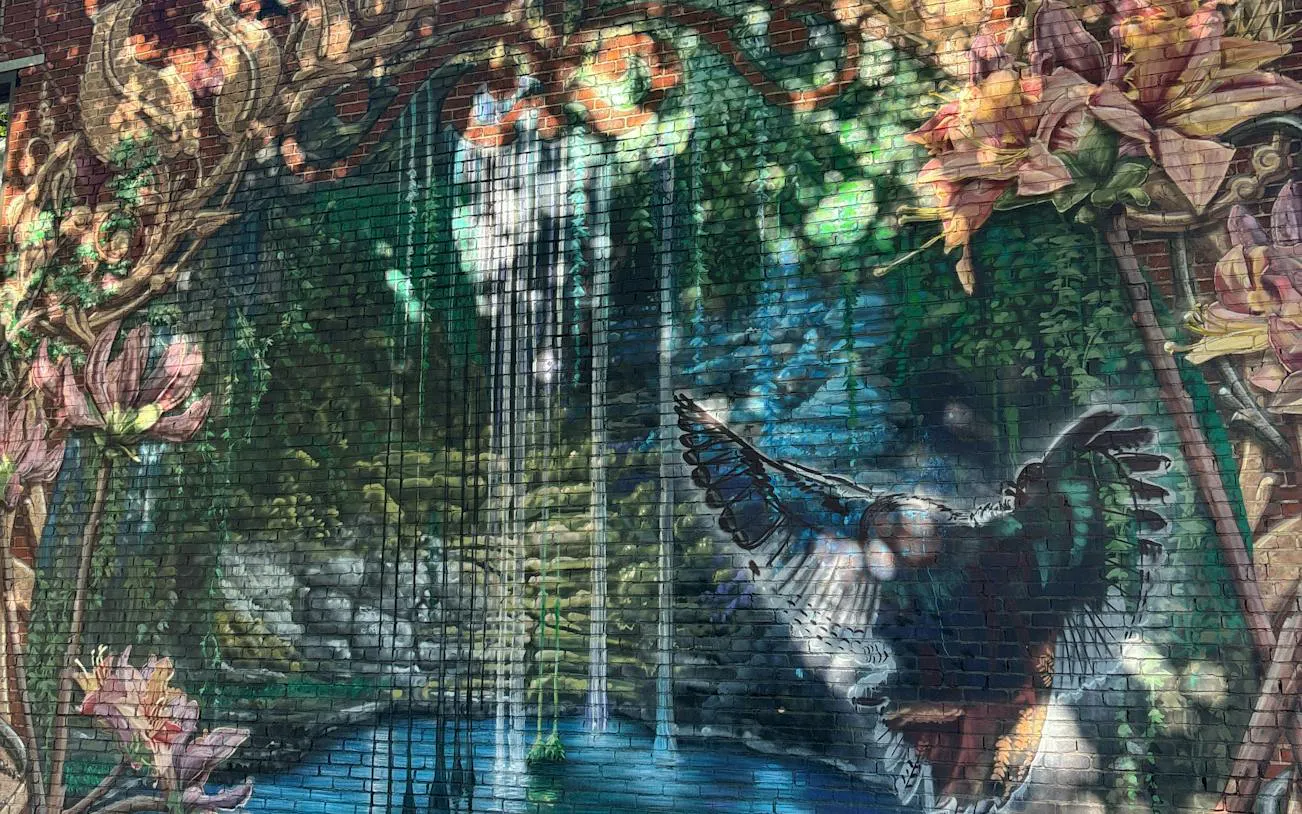Mural of a bird and waterfall in Montreal's Little Burgundy district.