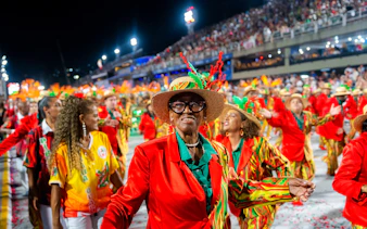 Performers in vibrant costumes at Rio Carnival 2027, Marquês de Sapucaí, Rio de Janeiro.