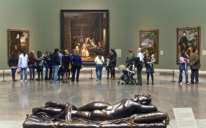 Visitors viewing Las Meninas painting at Prado Museum, Madrid.
