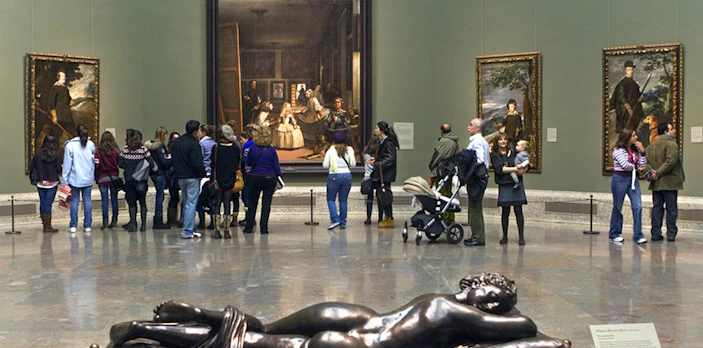 Visitors viewing Las Meninas painting at Prado Museum, Madrid.