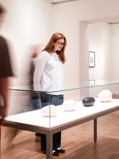Guests viewing sculptures at H’ART Museum exhibit.