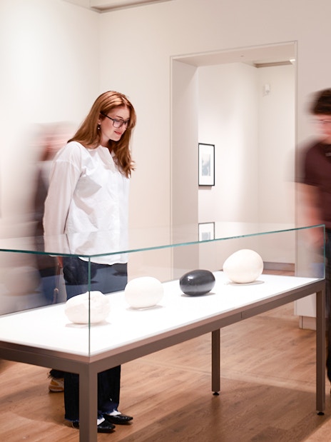 Guests viewing sculptures at H’ART Museum exhibit.