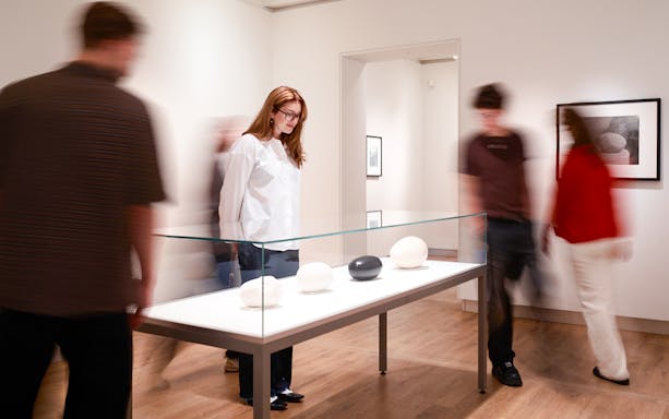 Guests viewing sculptures at H’ART Museum exhibit.