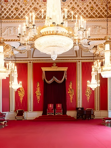 Buckingham Palace State Room with chandeliers and red decor.