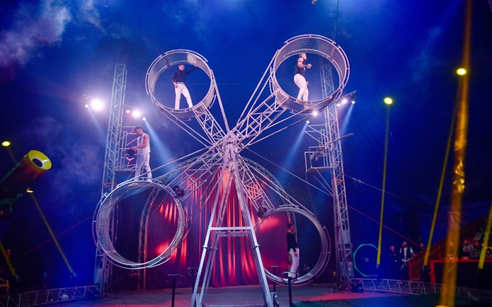 Performers on rotating wheels at Aqua Circus Phuket.