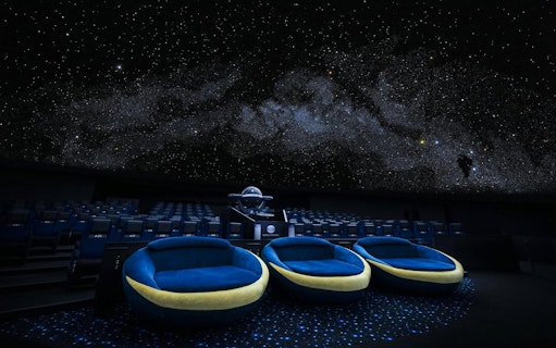 Crescent Moon Seats at Konica Minolta Planetarium Tenku, Tokyo Skytree under starry dome.