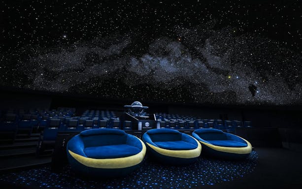 Crescent Moon Seats at Konica Minolta Planetarium Tenku, Tokyo Skytree under starry dome.