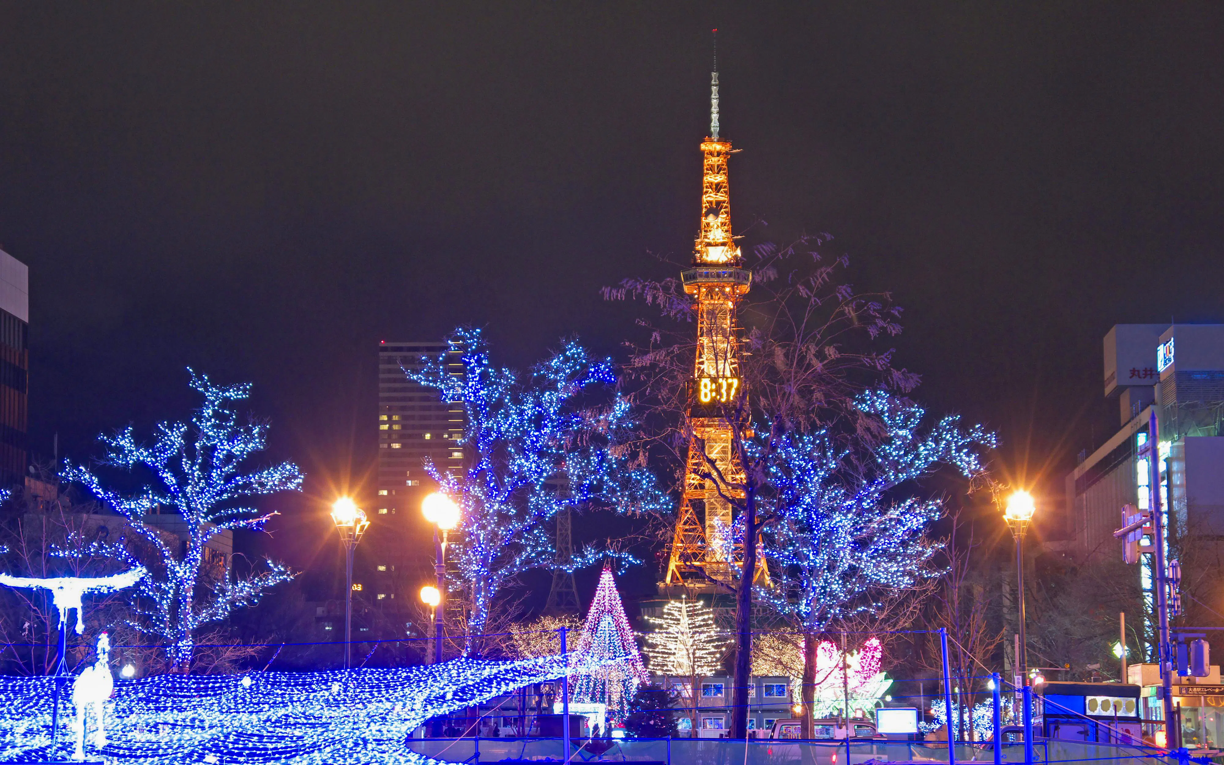 Sapporo TV Tower illuminated with winter holiday lights at night.