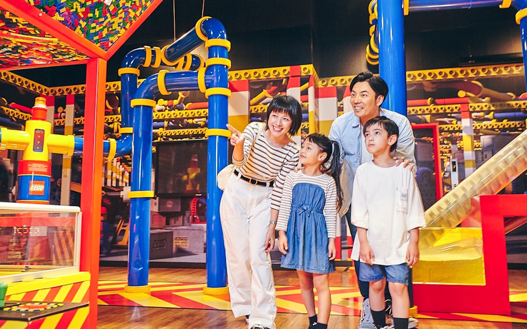 Family exploring interactive exhibits at LEGOLAND Discovery Center Tokyo.