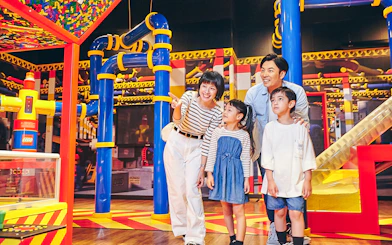 Family exploring interactive exhibits at LEGOLAND Discovery Center Tokyo.