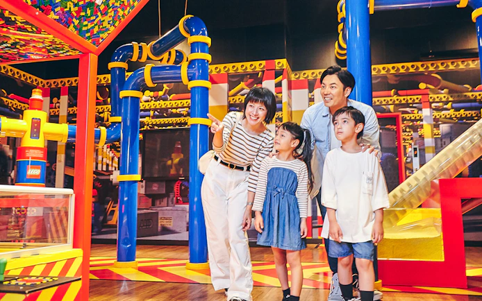 Family exploring interactive exhibits at LEGOLAND Discovery Center Tokyo.