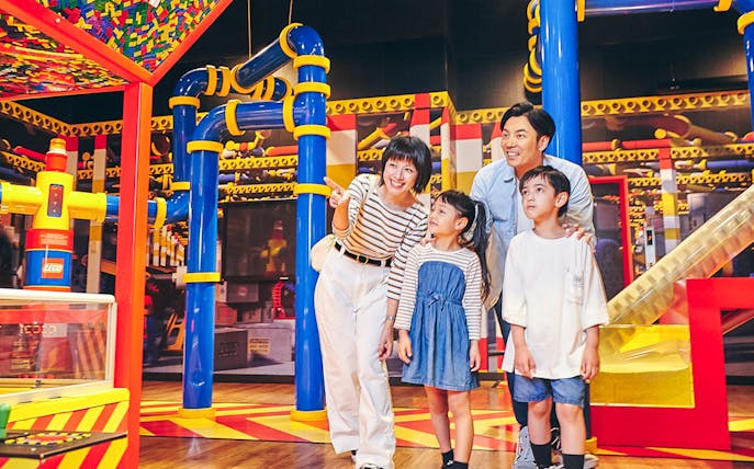 Family exploring interactive exhibits at LEGOLAND Discovery Center Tokyo.