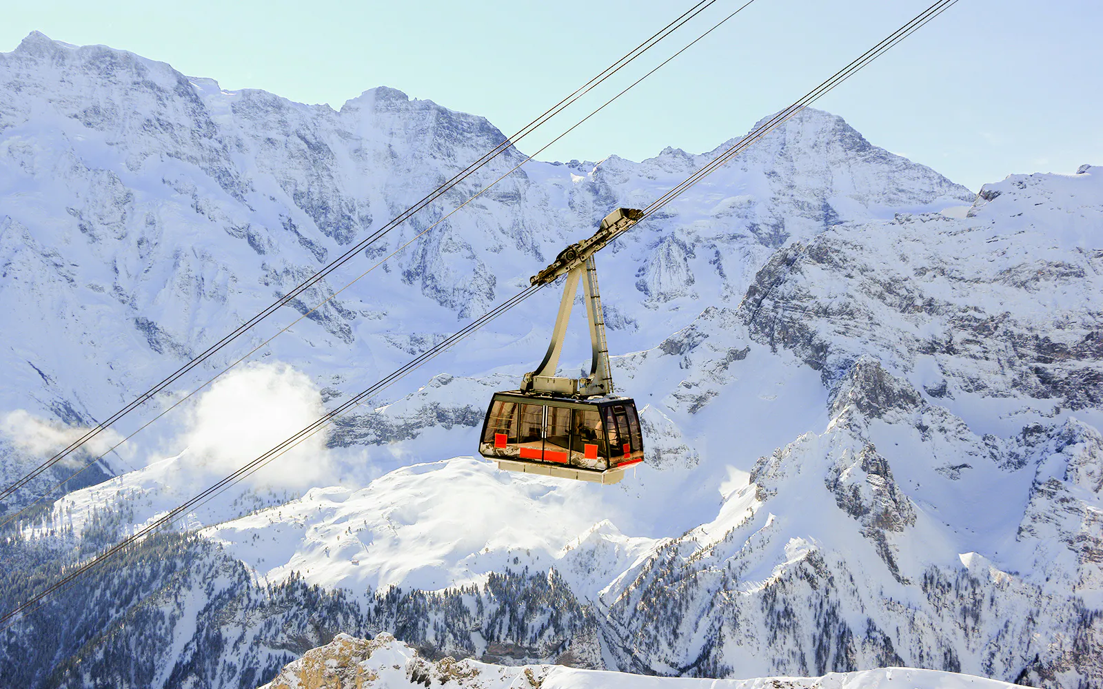 Cable car ascending to the Schilthorn summit in the Swiss Alps.